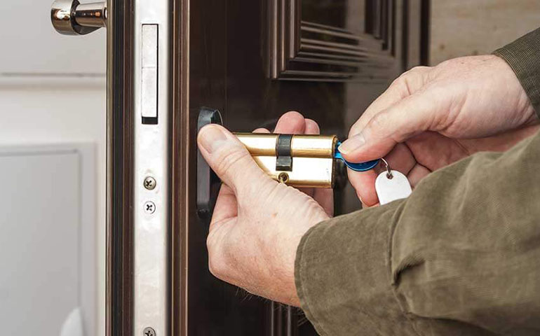Millennium Locksmith installing deadbolt on office door in Austin