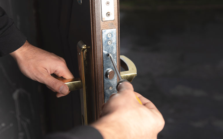 Residential locksmith in Austin TX rekeying front door lock